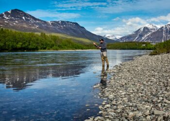 man fishing on the river